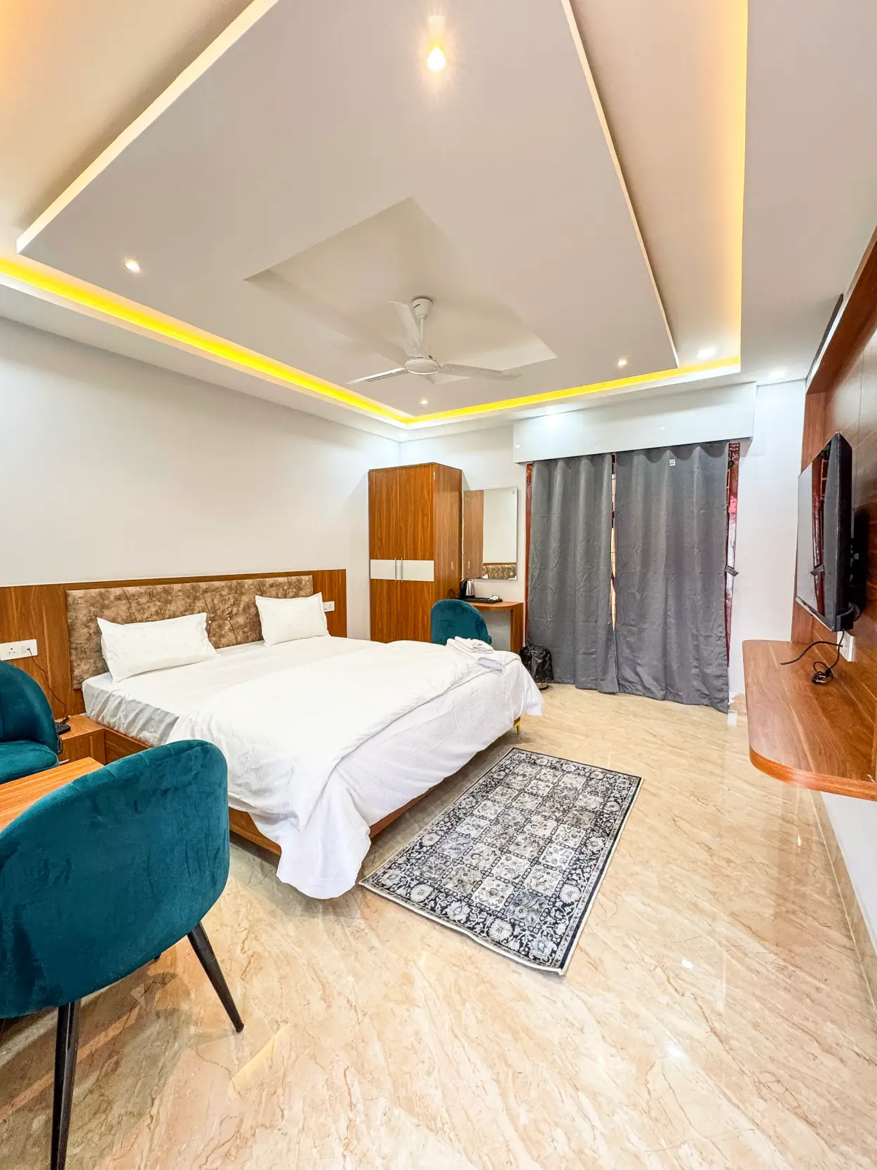 Deluxe room interior with bed and curtains